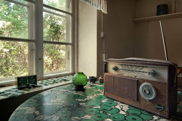 Retro radio receiver on the table next to it