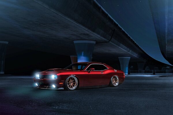 Red sports car with headlights on