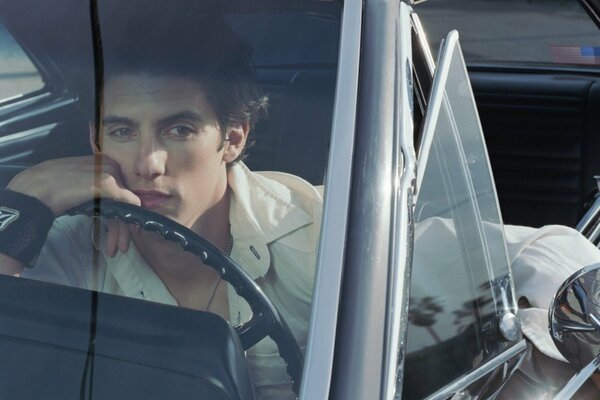 Thoughtful guy driving a car