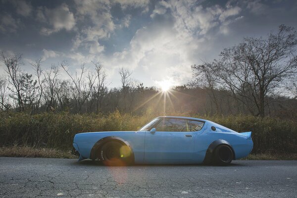 Blue Nissan in the setting sun