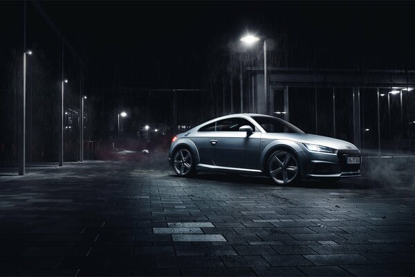 Silver car at night under a streetlight