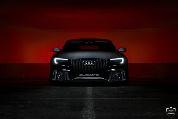 Black Audi on the background of a bloody sunset
