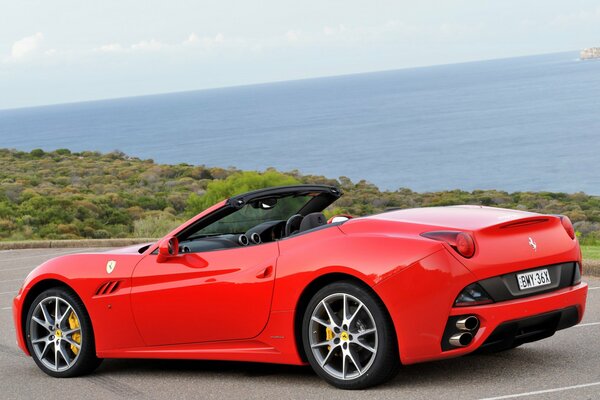Red ferrari california on the coast