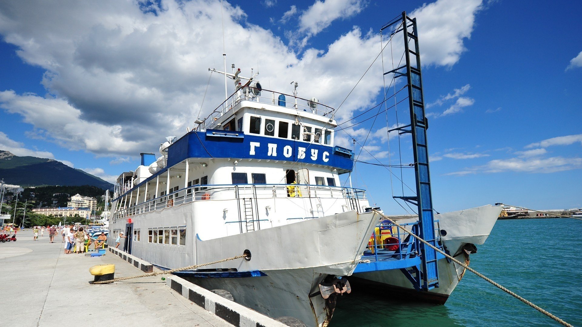 teamers yalta globe promenade pier marina clouds catamaran crimea people vacationers resort summer the sky mountains south coast transport