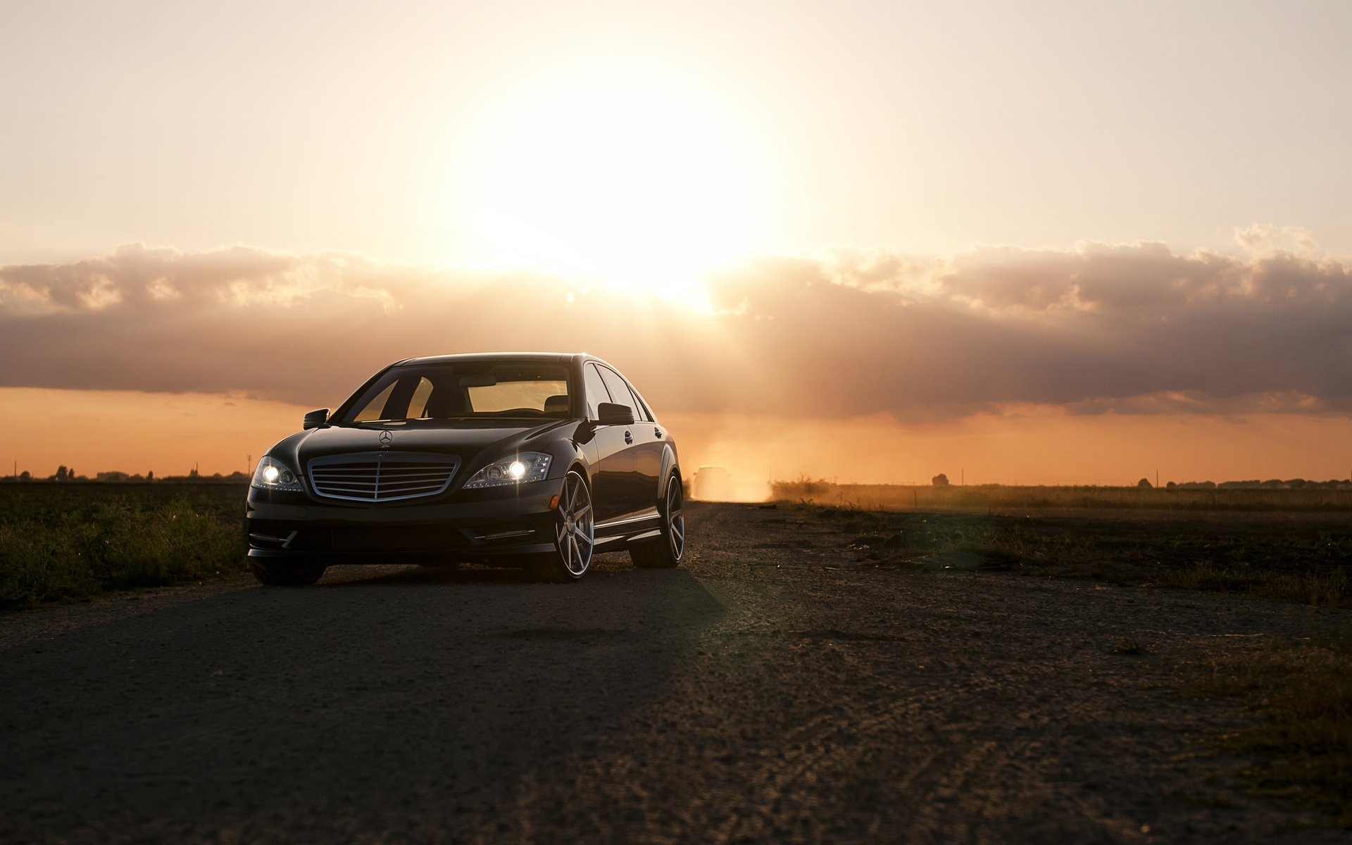 merc cook ket passenger cars cars auto transport cars sunset black car headlights clouds rays sun bright light mercedes wheelbarrow wheels riding road motor transport