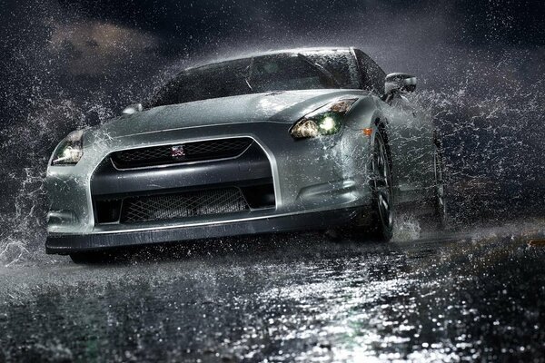 A gray car splashed from a puddle