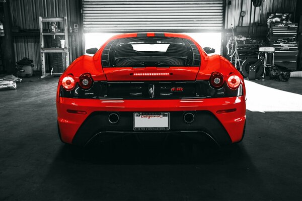Italian red ferrari f430 sports car in the garage