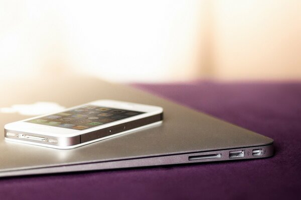 iPhone and MacBook are calm on the table