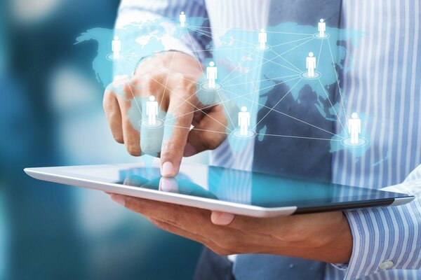 The man is working on a tablet. Graphics of communication between people
