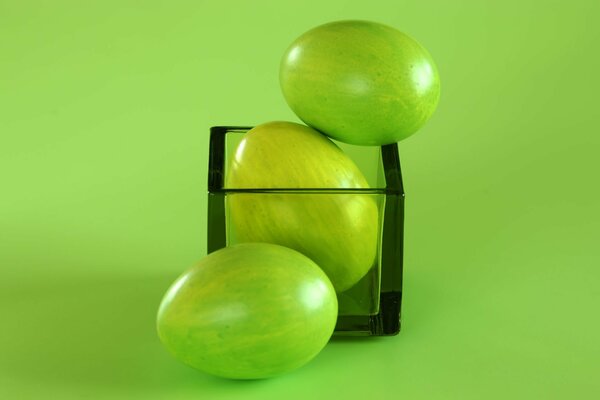 Green Easter eggs in a glass cube