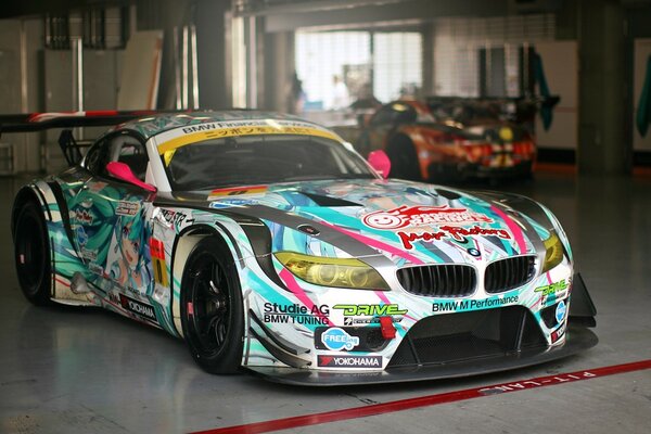 A multicolored BMW is parked at a service station