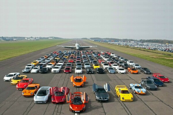 The runway. Cars of different colors and models