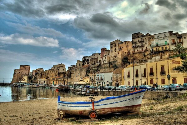 Boat on the shore of the picturesque Sicilian harbor