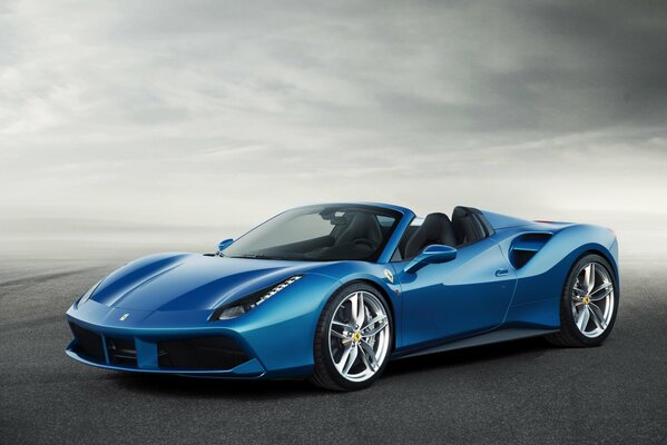 Blue racing Ferrari on the road in fog
