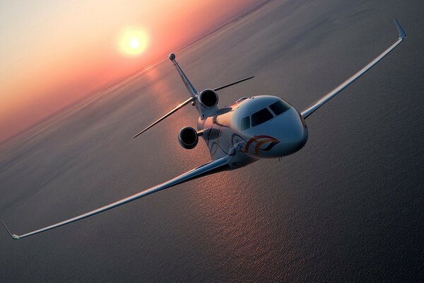 A liner flying by the sea at sunrise