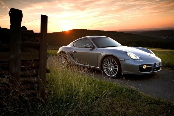 Grey Porsche cayman at sunset