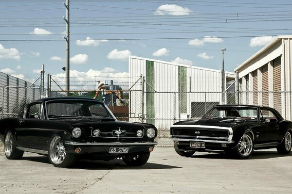 Retro Ford Mustang and chevrolet in the open air