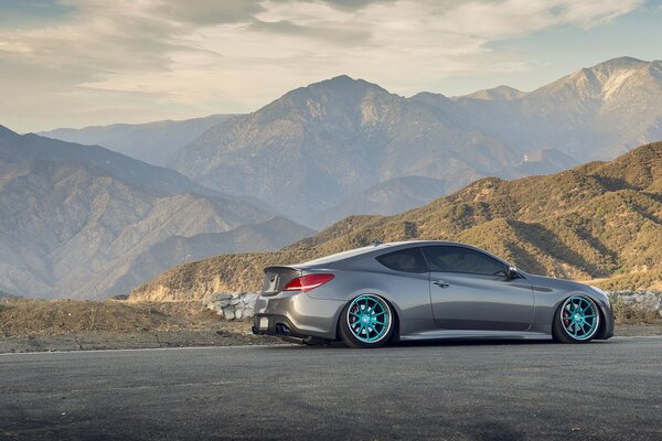 The gray car is in the mountains