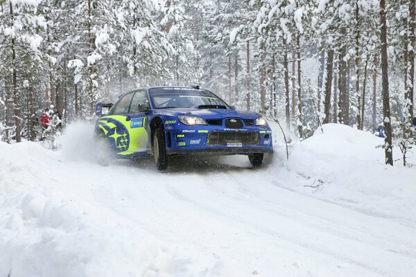 The car leaves the snow-covered forest