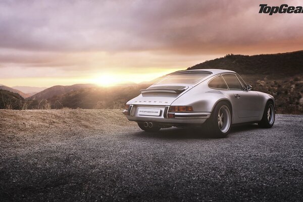 A small Porsche on the background of the sunset