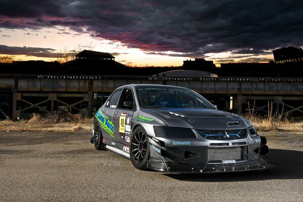 Mitsubishi stands against the background of a clouded sky