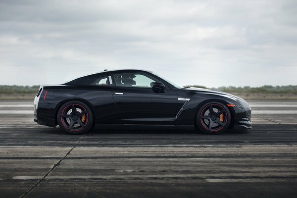 Black Nissan car on the road