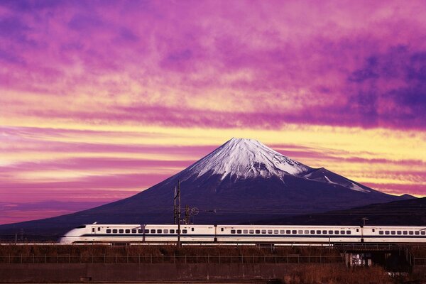 The train passes by a big mountain