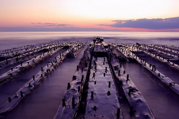 Blocks in the sea on the background of a beautiful red sunset