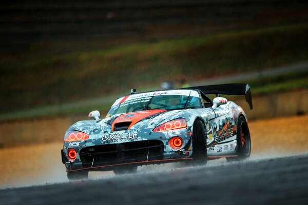 Racing car drifts in the rain