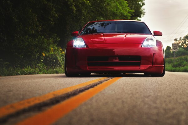 Red nissan 350z on the road front view