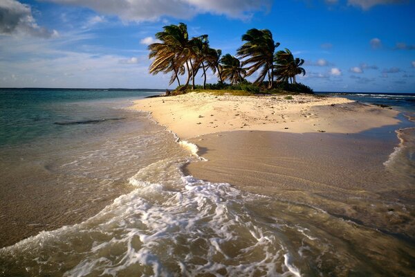 An island in the ocean against the sky