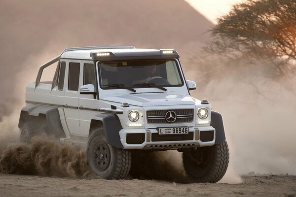 White Mercedes Benz jeep on a dusty road