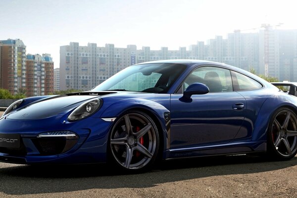 Porsche carrera 911 on the background of high-rise buildings
