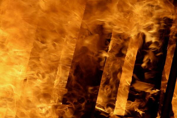 The flame of fire completely enveloped the wooden structures