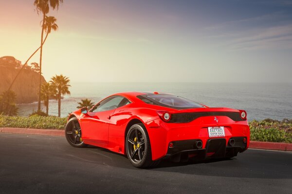 Red ferrari 458 speciale on the ocean
