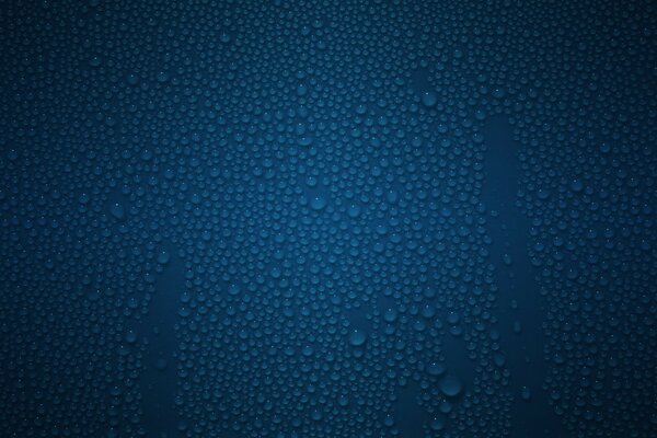 Blue transparent drops on the glass