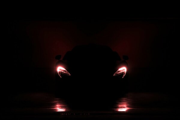 Sports car headlights in complete darkness