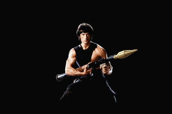 Sylvester Stallone as Rimbaud on a black background with a gun