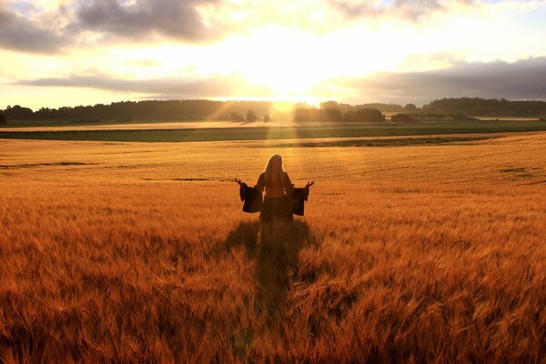Photo of a girl in a field against the horizon