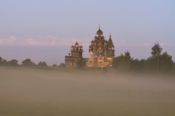 Church on a hill in the fog in summer
