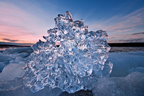 Shiny transparent ice on the background of sunset
