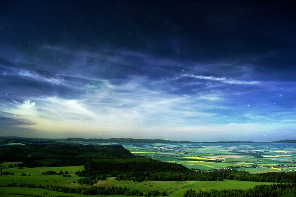 Blue sky over a green plain