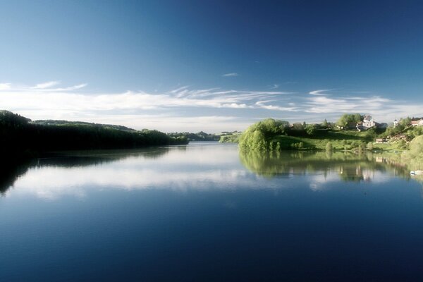 A pond near the village. Blue sky