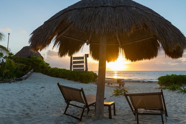 A tropical paradise by the sea and sunset