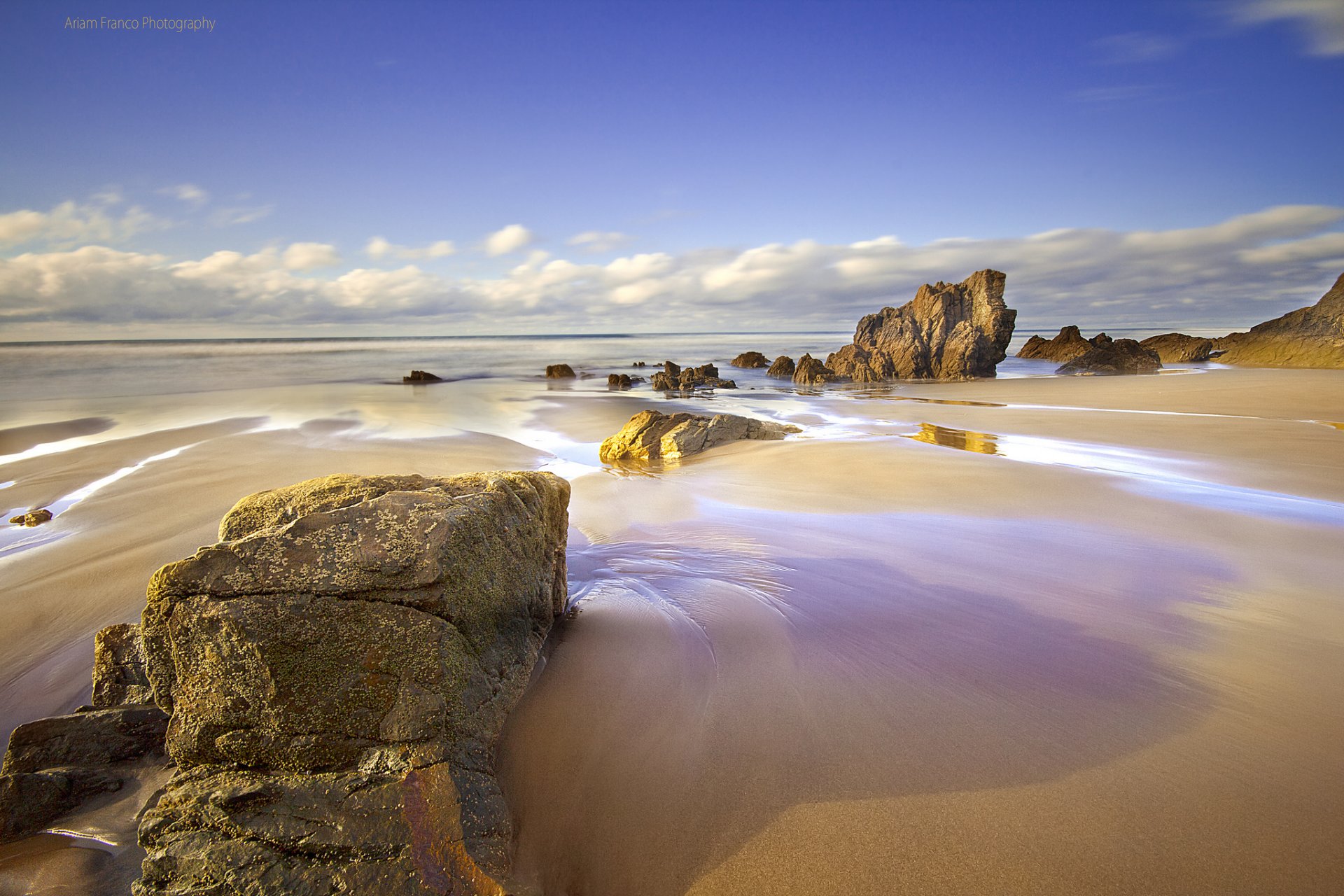 pain asturias beach sand sea rock sky clouds spring april