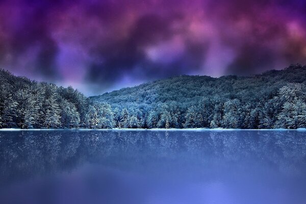 Forest mountains on the background of the lake and the night sky