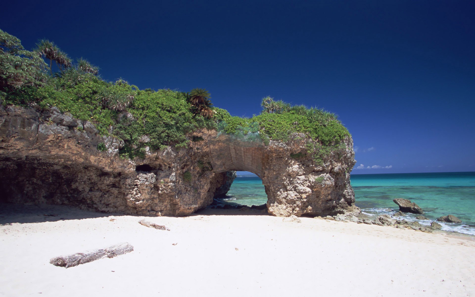 japan okinawa beach sea ocean sand arch rock stones green