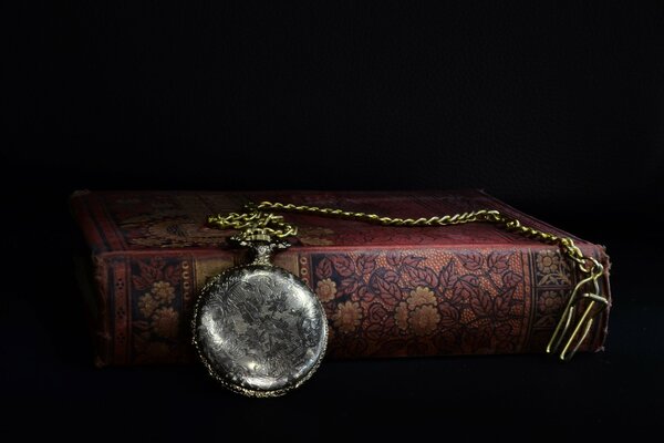 Pocket watch with a chain on the book