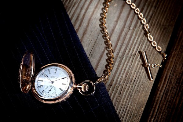 Vintage pocket watch with chain on the table