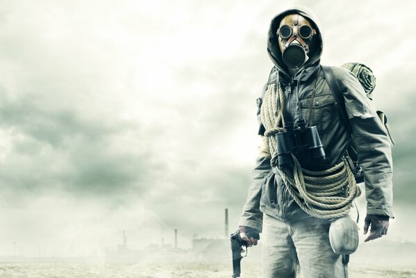 A post-apocalyptic man in a gas mask with a gun